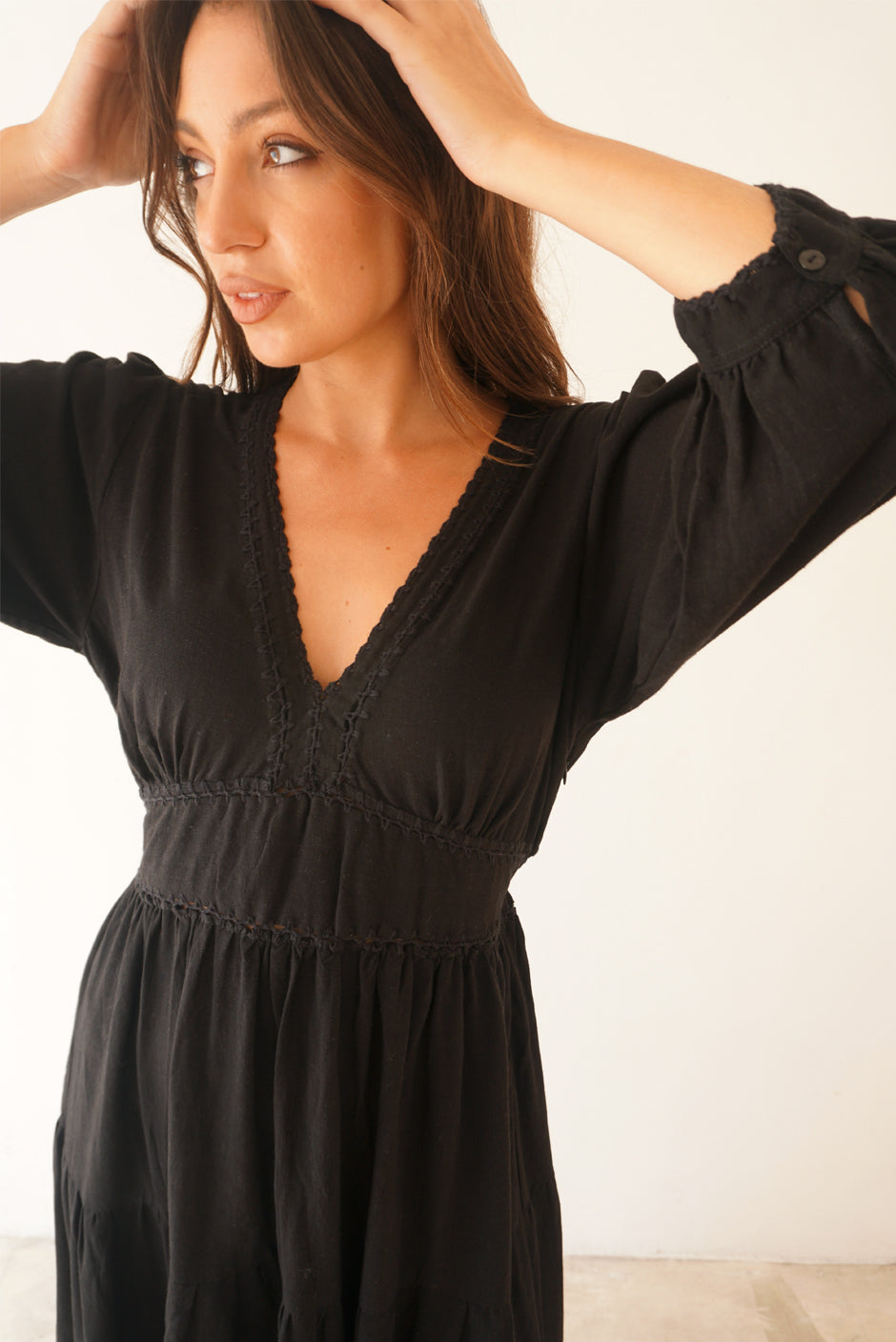 Black Crochet 3/4 Sleeve Women's Maya Below-the-knee Midi Dress from Paneros Clothing with 100% certified sustainable fabric, embroidery, and smocking. Crochet close up details.