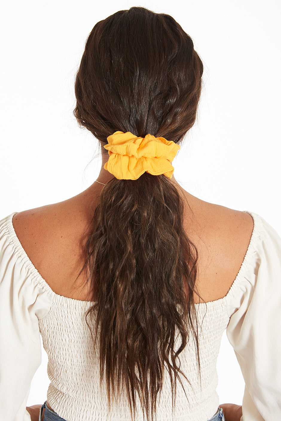 Babe scrunchie in solid Mango color on long female hair by Paneros Clothing. 100% Rayon from sustainable leftover fabric.