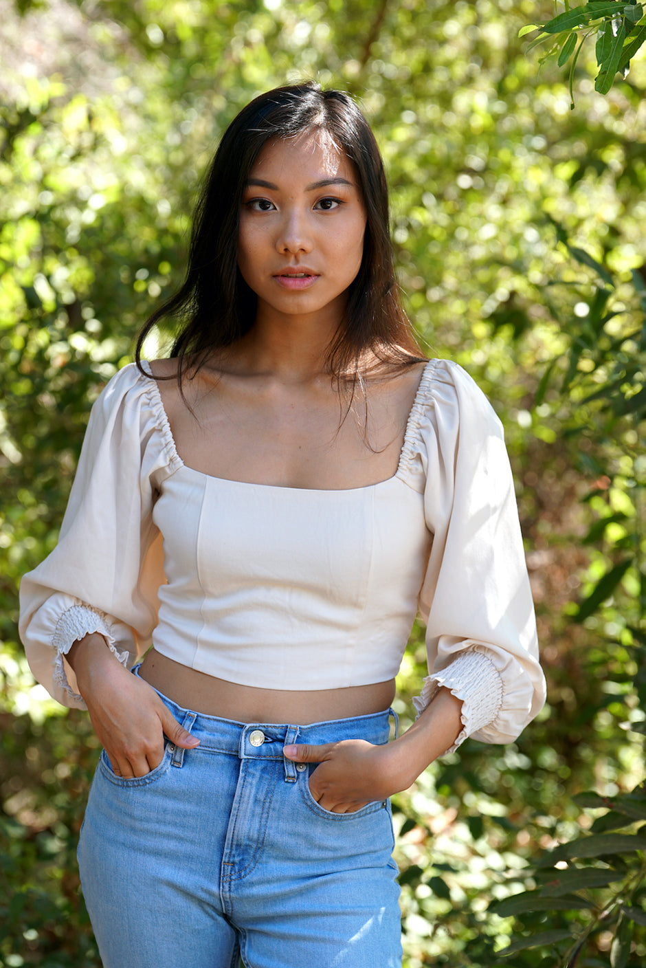 Liv Crop Top in Coconut Milk for women by Paneros Clothing. Square neckline with smocked back and elastic at shoulders, 3/4 length sleeves. 100% Tencel. Front View on shoulders.