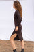 Sasha Knitted Dress in Espresso Brown color for women by Paneros Clothing. Reversible Peekaboo cut out detail in front and hits below the knee and features a side slit and a rib knit. Handknitted from 100% cotton side view.