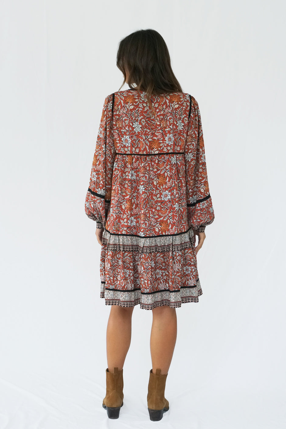 Brown Floral Print Long Sleeve Women's Sierra Above-the-Knee Mini Dress from Paneros Clothing with 100% certified sustainable fabric and smocking. Back View.