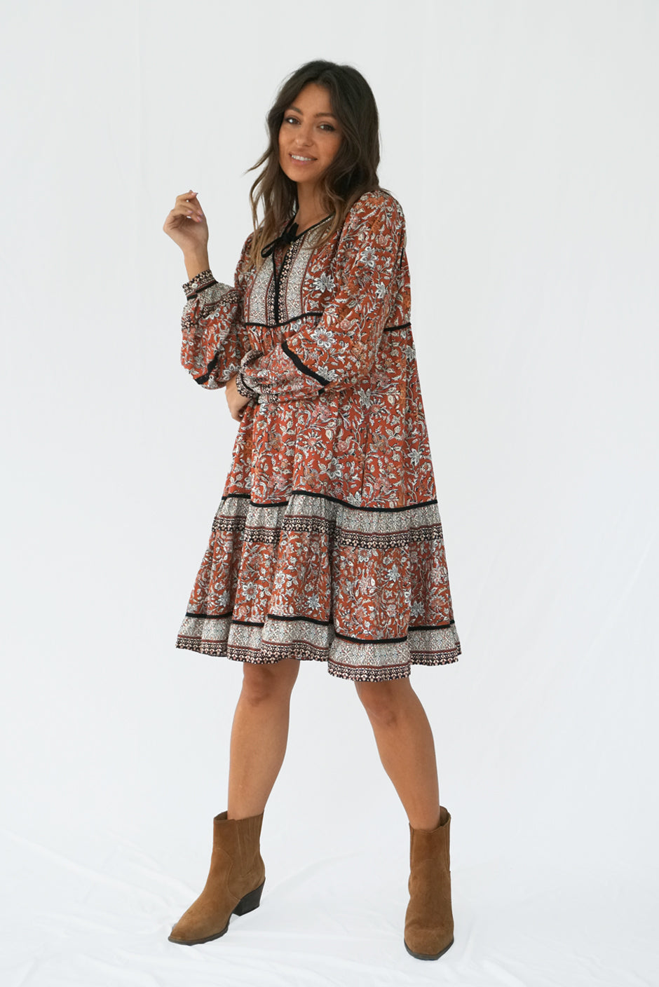 Brown Floral Print Long Sleeve Women's Sierra Above-the-Knee Mini Dress from Paneros Clothing with 100% certified sustainable fabric and smocking. Side View.