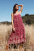 Paneros Clothing - Sustainable Fashion Ethical Designer Red/Pink Floral Paisley Print Maxi Smocked Dress with Ties for Women - Lifestyle Image.