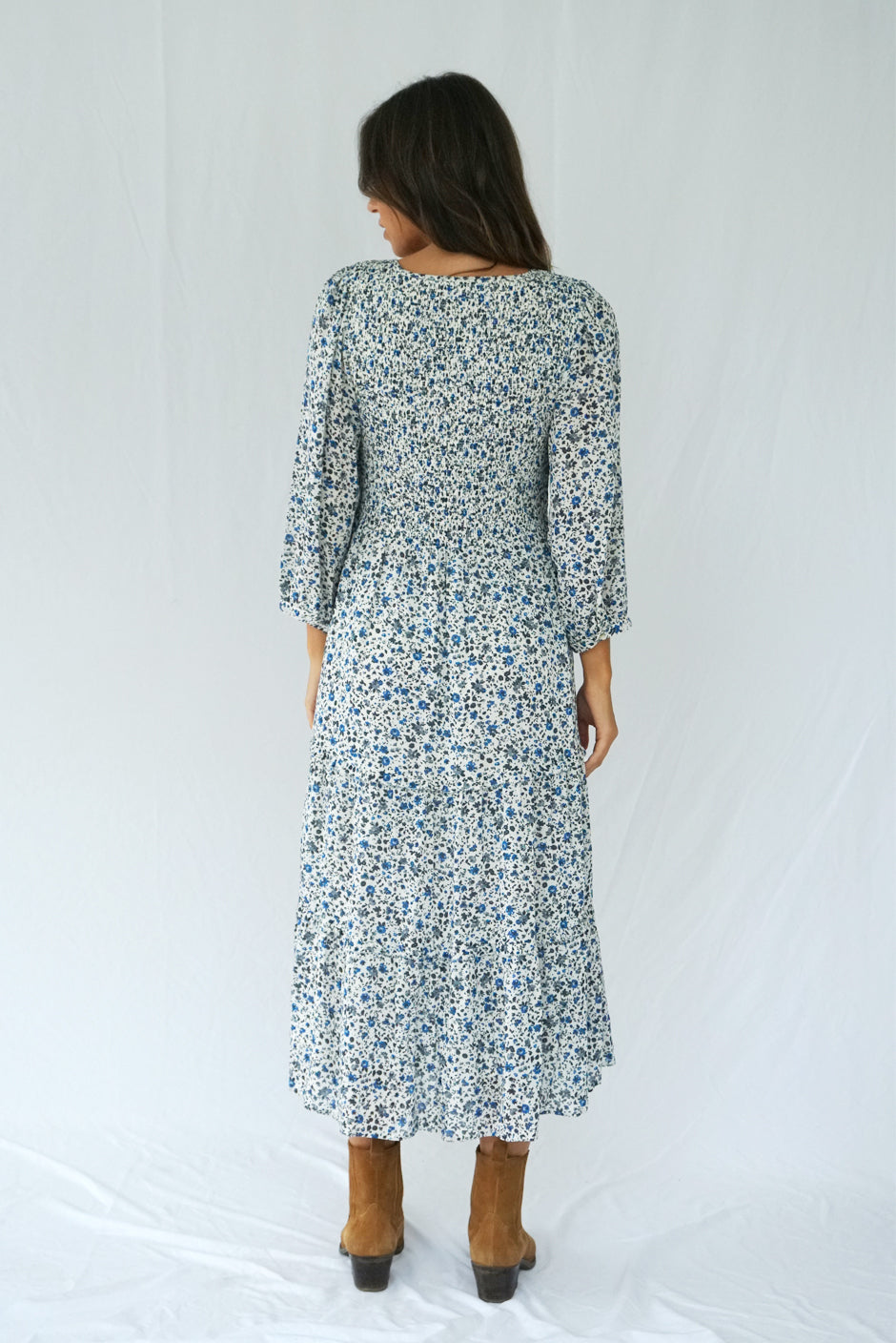 Floral Print Long Sleeve Women's Stella Below-the-Knee Midi Dress from Paneros Clothing with 100% certified sustainable fabric and smocking. Back View.