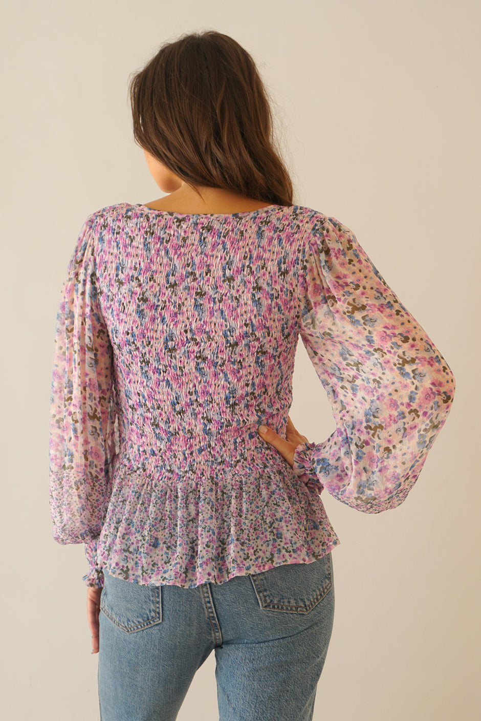 Purple Pink Floral Print Blouse Top for Women with smocking, ruffle details, and full length sleeves from Paneros Clothing: the Stella Top. Back View.