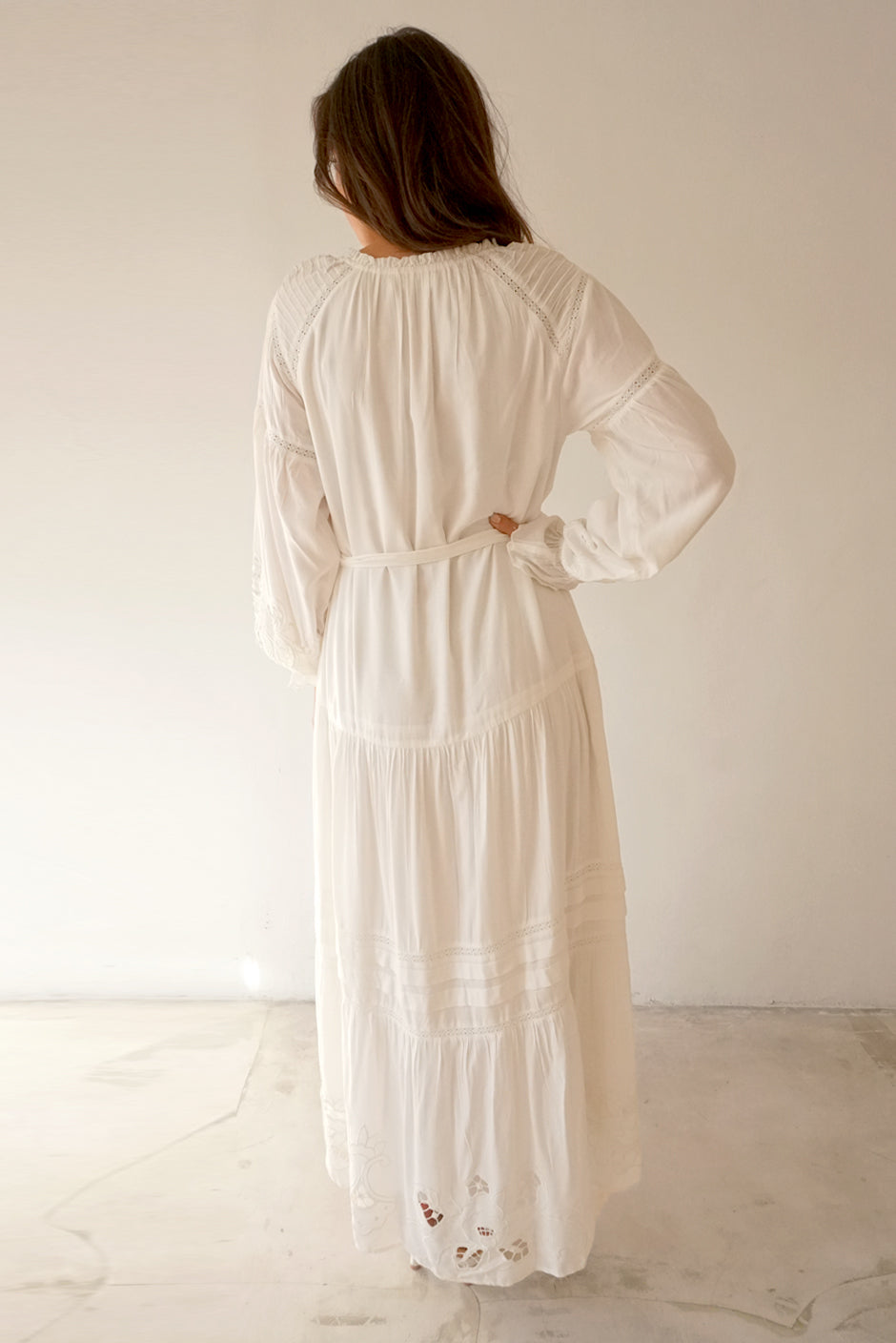 White Button-up Midi Dress for Women with lace and embroidery details in the sleeves and skirt, full length sleeves from Paneros Clothing: the Stevie Dress. Back view with embroidery and white tie belt.