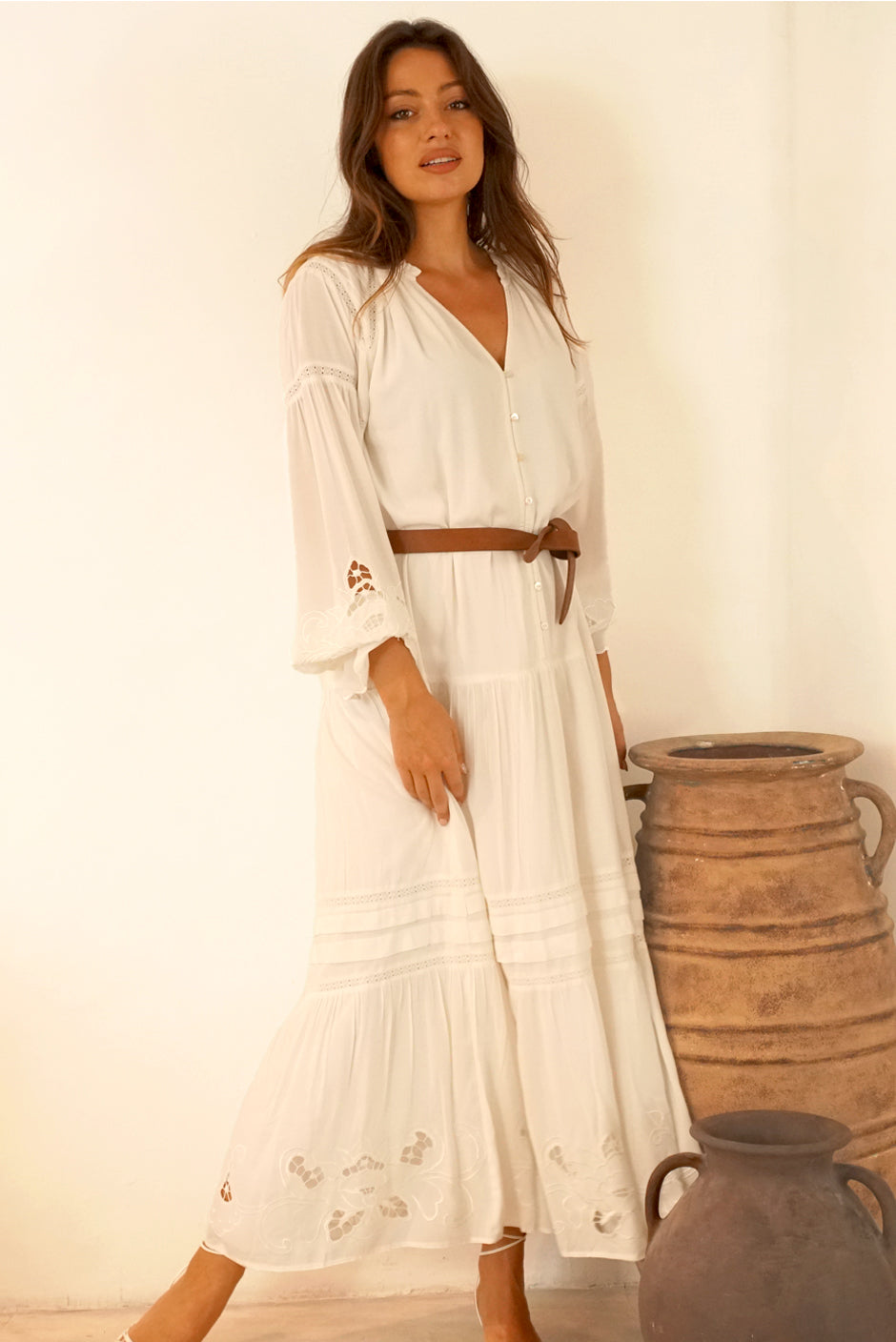 White Button-up Midi Dress for Women with lace and embroidery details in the sleeves and skirt, full length sleeves from Paneros Clothing: the Stevie Dress. Front View styled with leather belt.