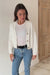 Bright Sugar White sustainable cropped-length Cotton Diana Cardigan from Paneros Clothing with real coconut shell button-up front, Full sleeves, and feminine handknittting. Full Body View in motion, unbuttoned.