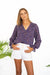 Purple Boho Print Spring/Summer 2022 Aria Blouse from Paneros Clothing with V-neckline and long sleeves. Front View tucked into White Shorts.